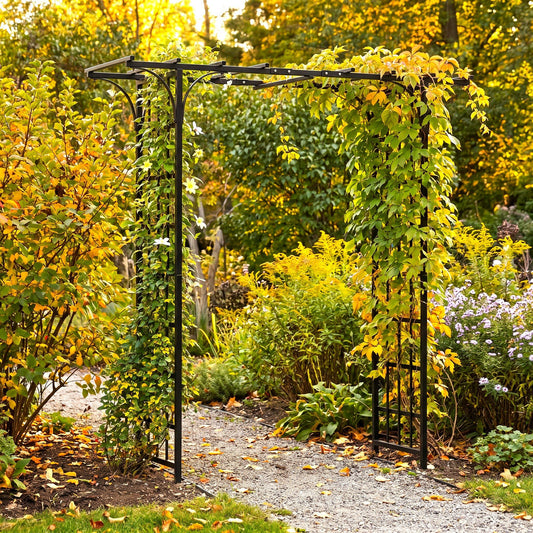 h potter brand black metal garden arbor with climbing green and yellow foliage, set in a lush garden pathway surrounded by autumn foliage.