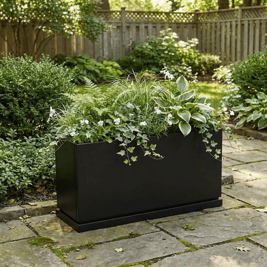 h potter hawthorne black rectangular planter on stone patio with green flowers