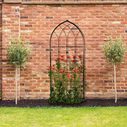 H Potter large black gothic wrought iron garden trellis, freestanding outdoors against a brick wall