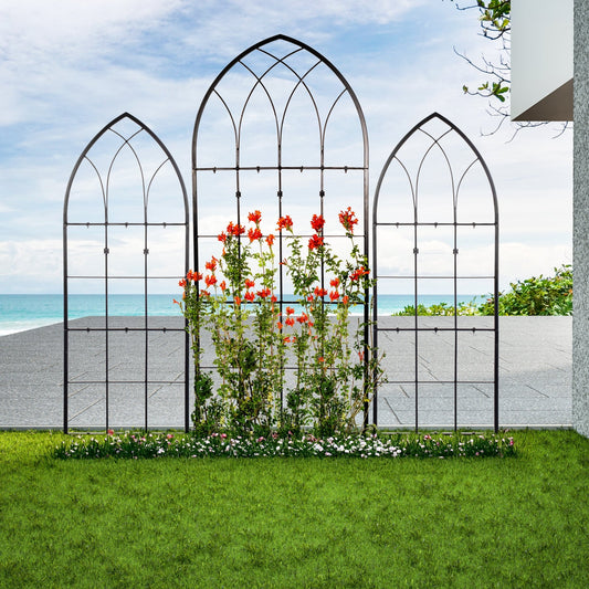 Decorative metal garden arches with plants and flowers in a garden setting.