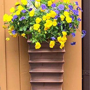 H Potter brand metal garden planter plant container at front door entryway with pansy flowers
