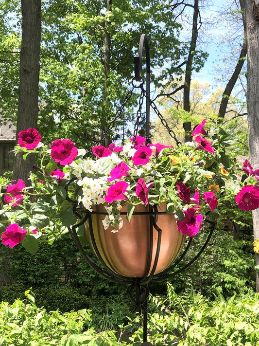 H Potter brand hanging round copper planter with flowers outside landscaping in backyard