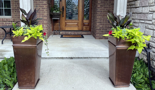 H Potter brand metal garden planter plant container at front door entryway outdoors