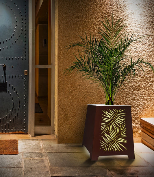H Potter Brand Metal LED lit planter with laser cut fern design outdoors at front door entryway of home