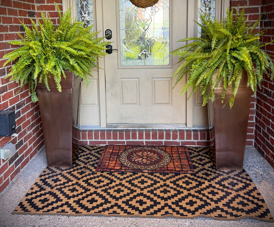 H Potter brand metal garden planter plant container at front door entryway with fern flowers outdoors