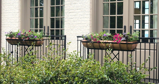 H Potter brand copper window boxes with flowers hanging hear the outside of a house above a flower garden with plantes