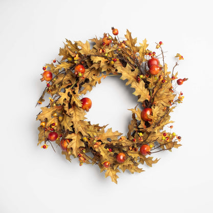 Autumn wreath with leaves and apples on a white background