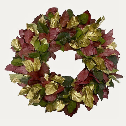 decorative christmas wreath with red green and gold leaves on a white background