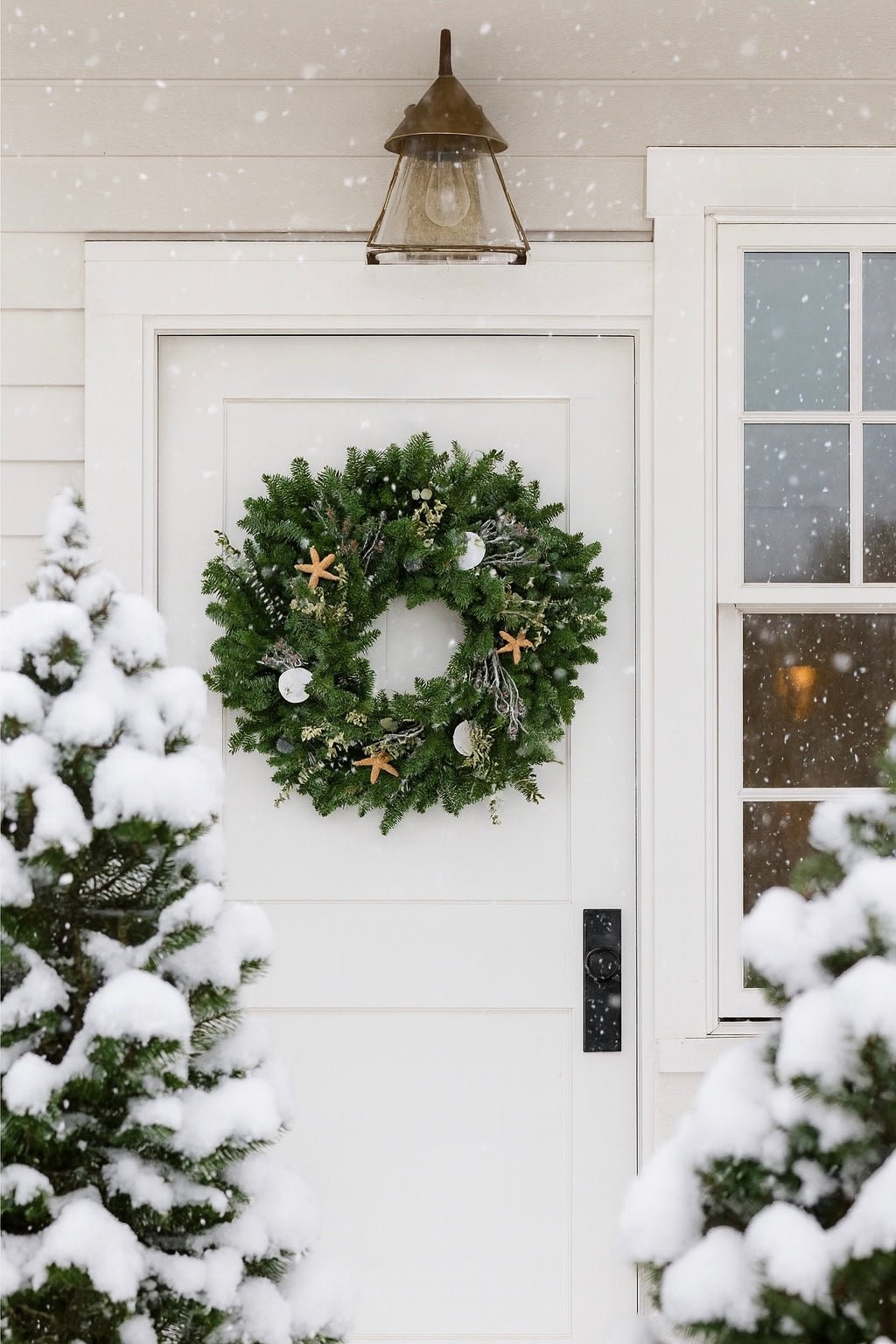 Christmas Wreath with decorative ocean accents, starfish seashells on a front door
