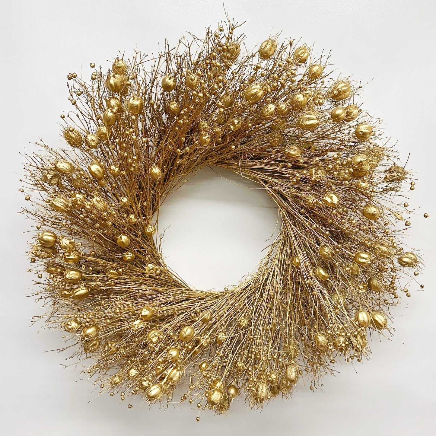 decorative Christmas wreath dried botanicals gold on a white background 