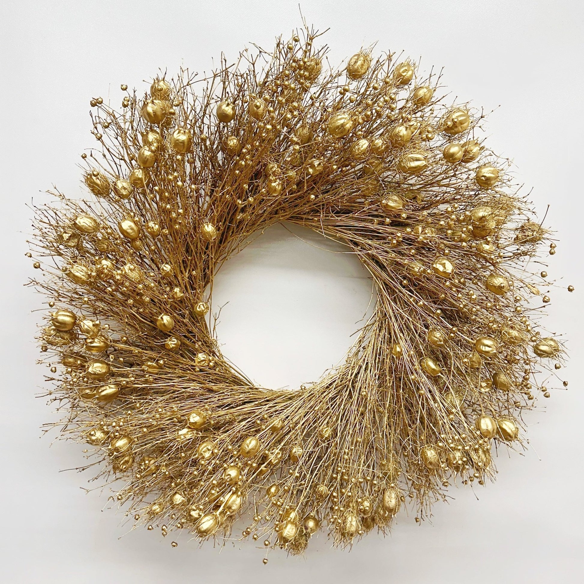 decorative Christmas wreath dried botanicals gold on a white background 