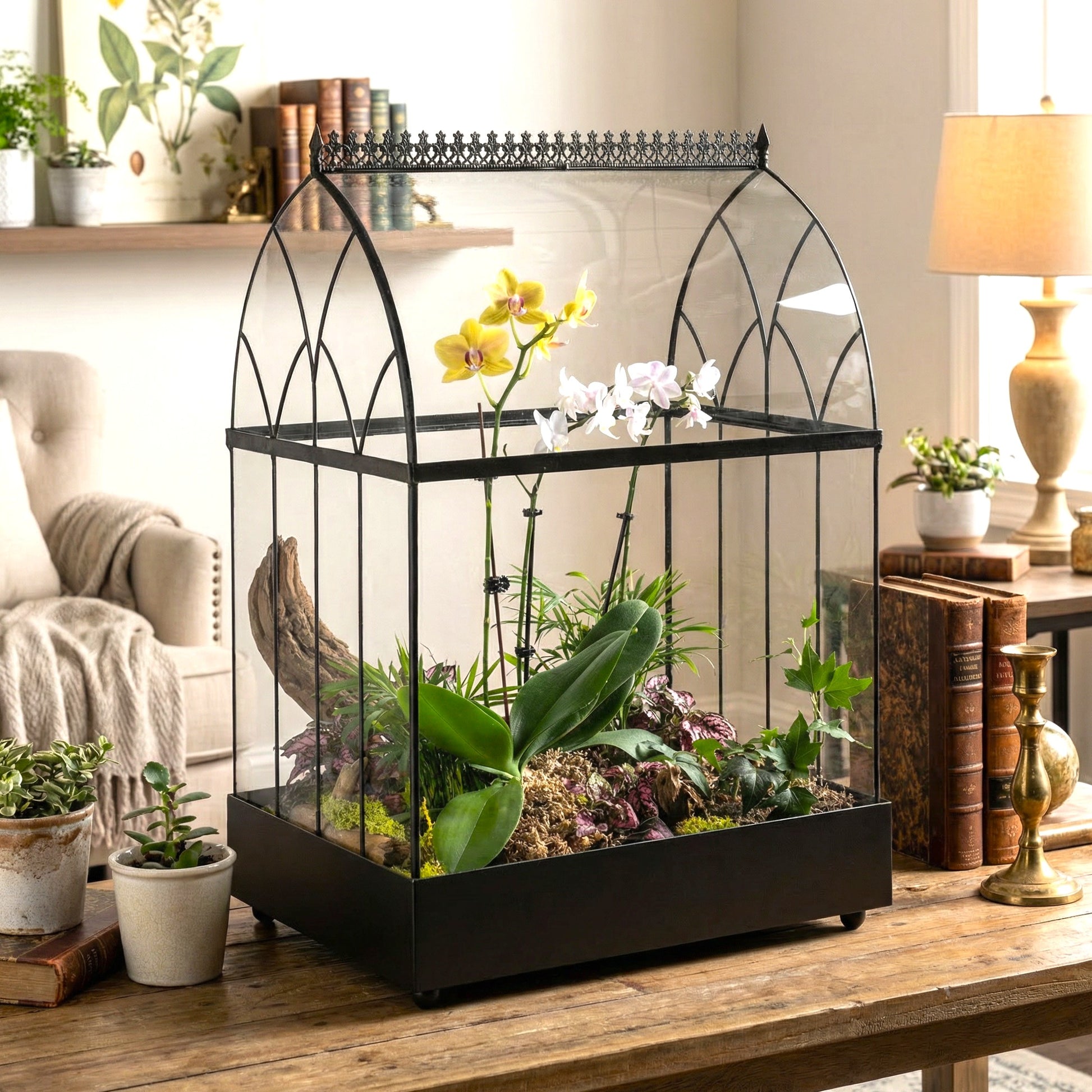 Glass terrarium with plants on a wooden table in a home setting