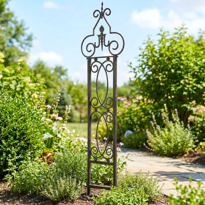 Decorative metal garden trellis in a lush garden setting with greenery and a clear sky.