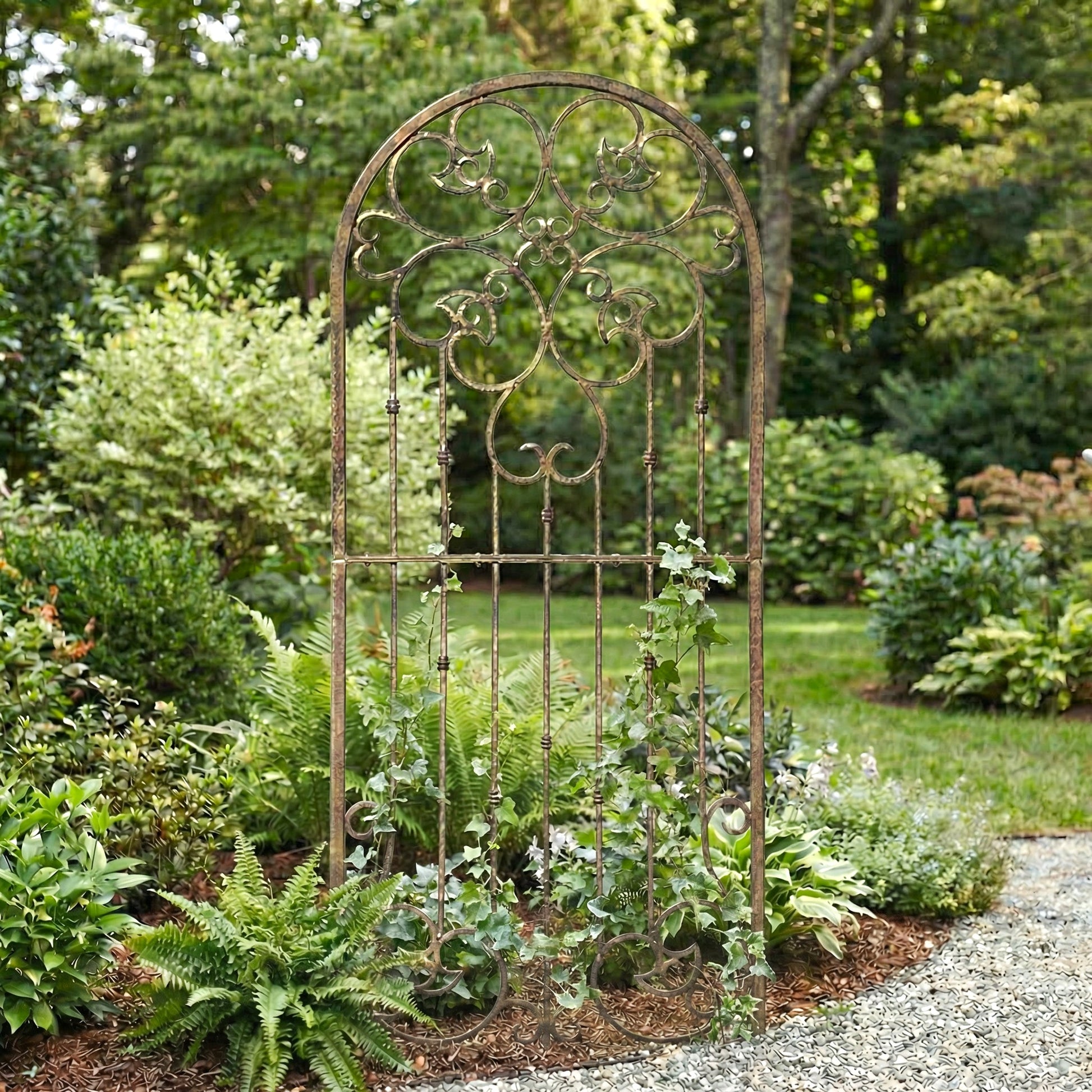 Decorative metal garden archway in a lush garden setting