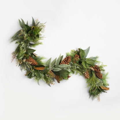 Green christmas wreath with pine cones on a white background