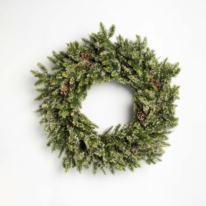 Green Christmas wreath with pinecones on a white background