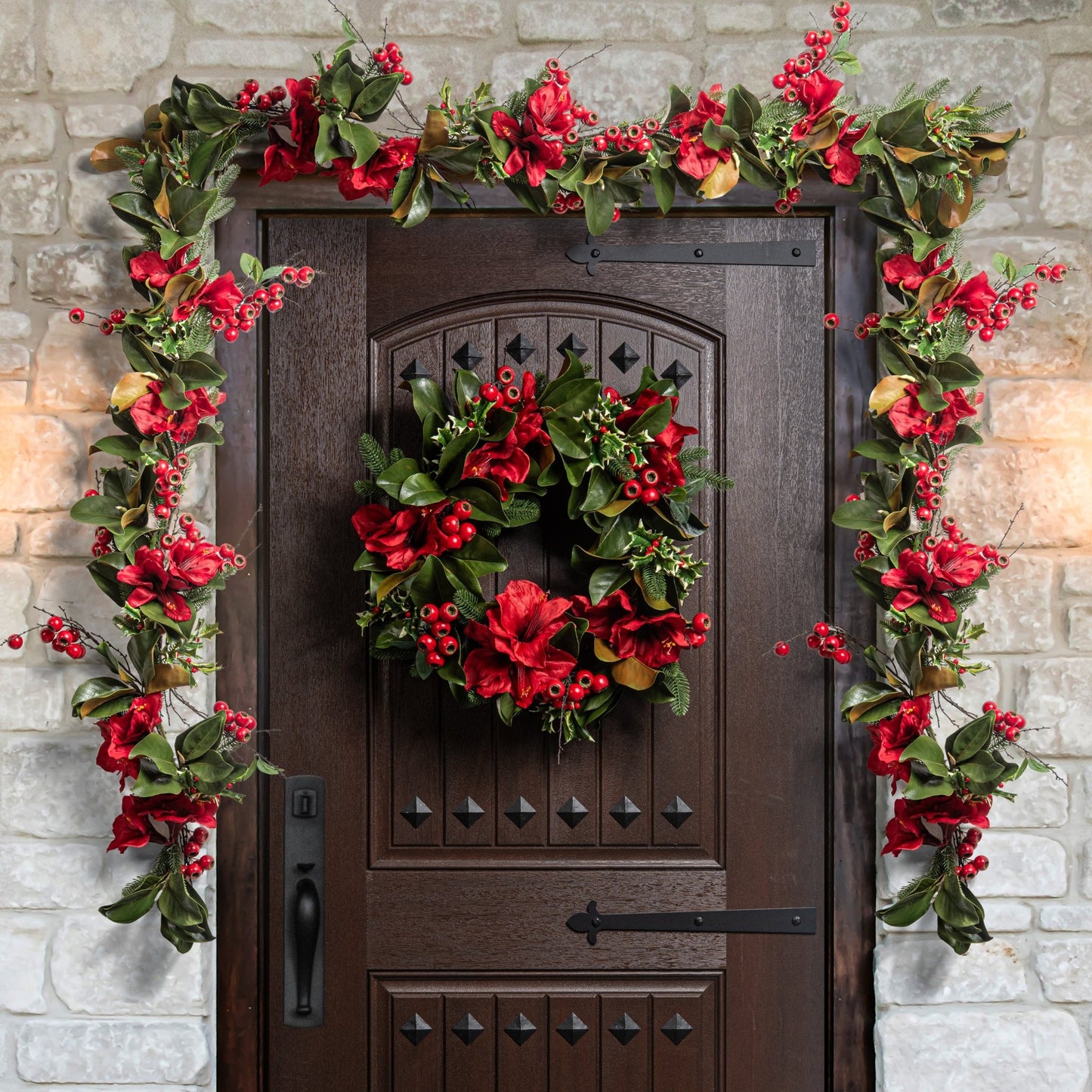 Decorative christmas wreath and garland on a door with stone wall background