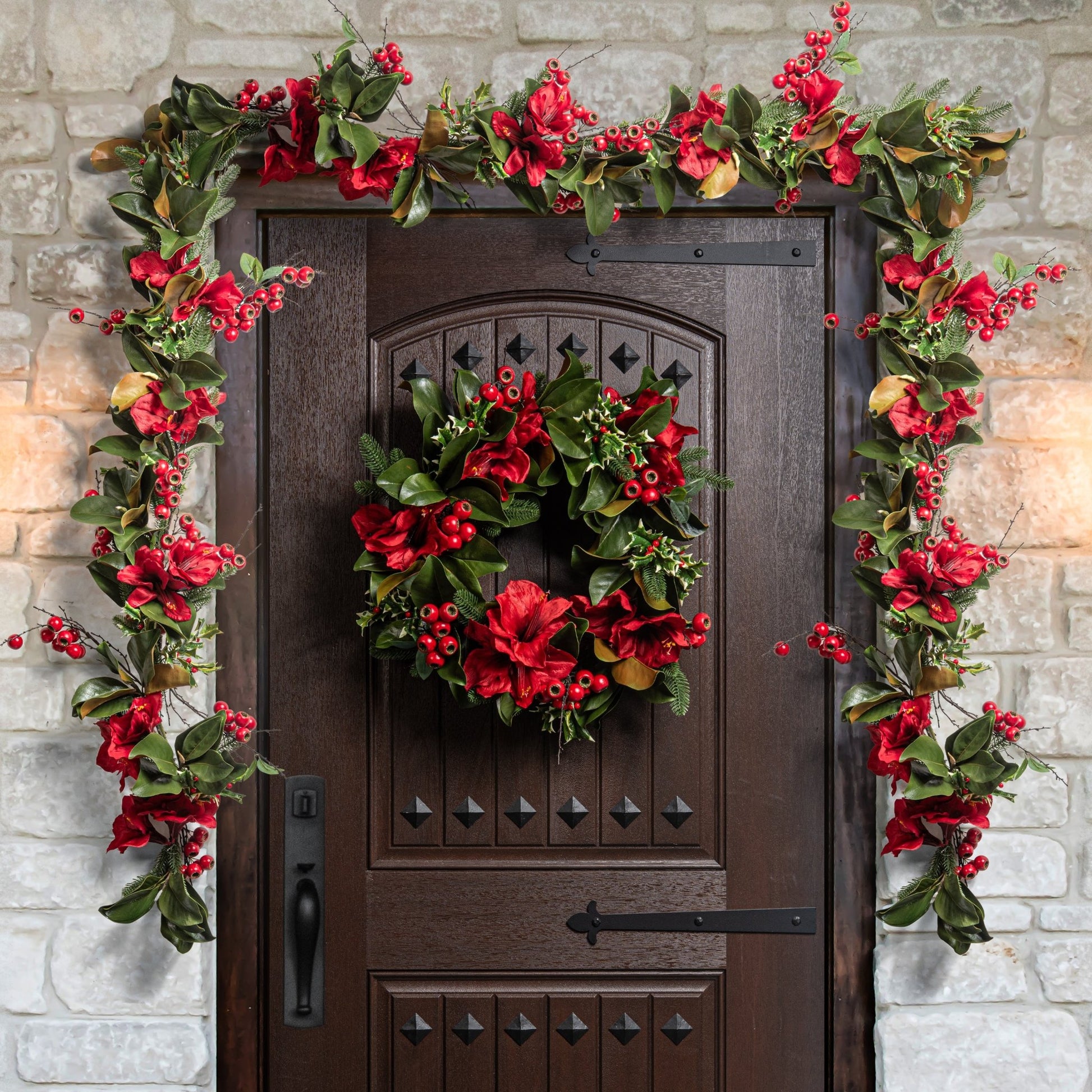 Decorative christmas wreath and garland on a door with stone wall background