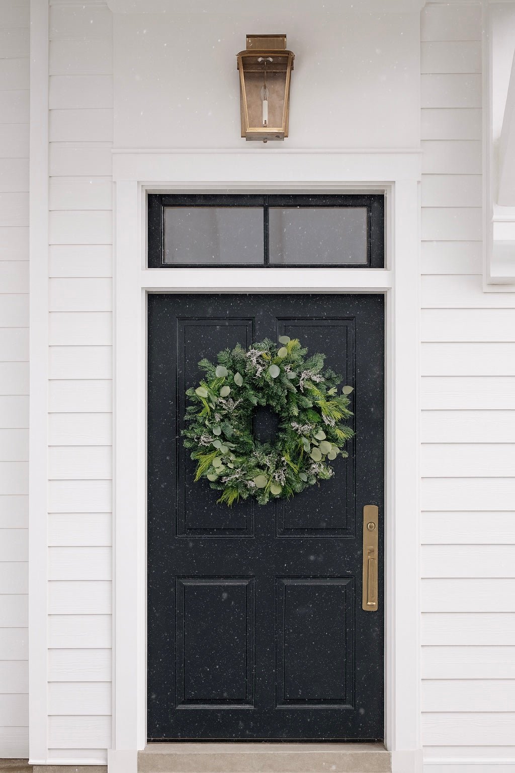 H Potter fresh evergreen Christmas wreath displayed on a black front door