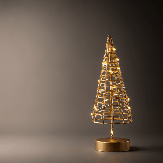 A gold wireframe cone-shaped decorative tree with warm glowing lights and a round gold base, photographed against a dark gray studio background.