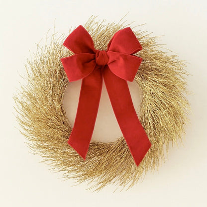 decorative gold christmas wreath with red bow on a white background