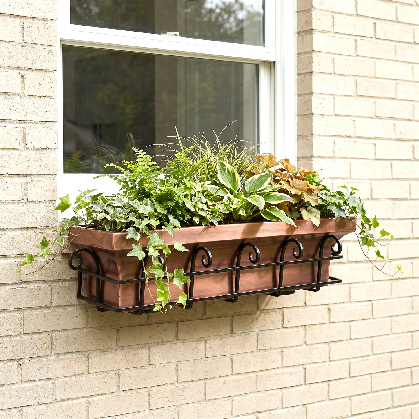 H Potter antique copper window box with flower on a brick house