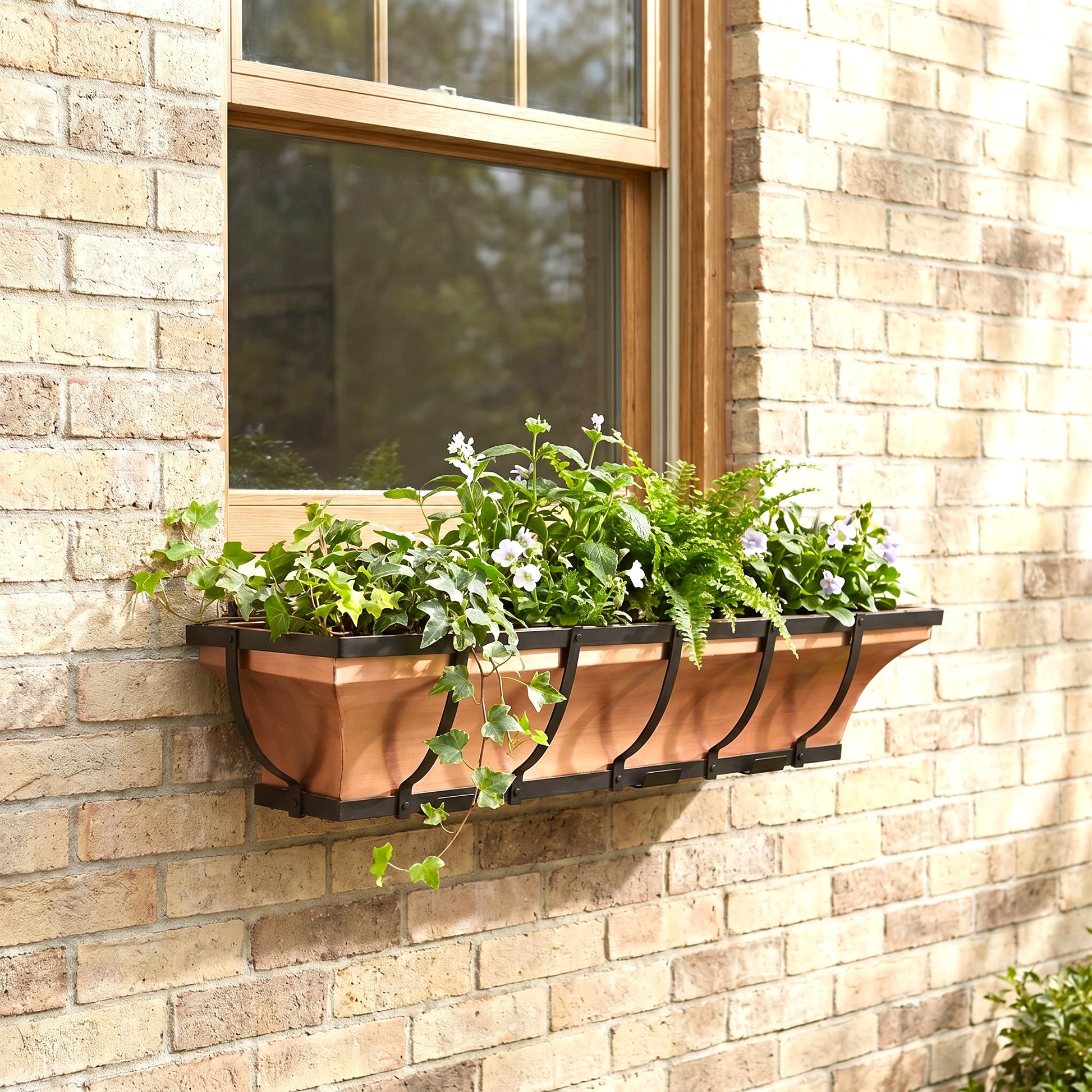 H Potter 36 inch copper window box with black metal frame on a brick house