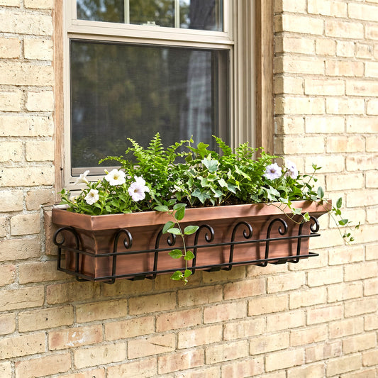 H Potter antique copper window box with blacking mounting frame on a brick house with flowers