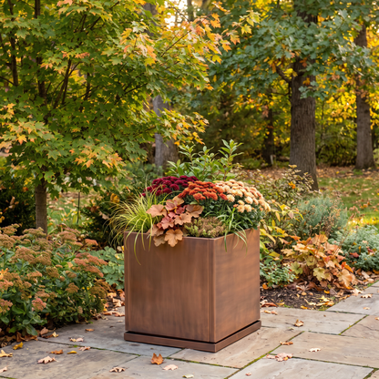 H Potter Ashbury 17-inch square antique copper planter with fall flowers in an outdoor garden