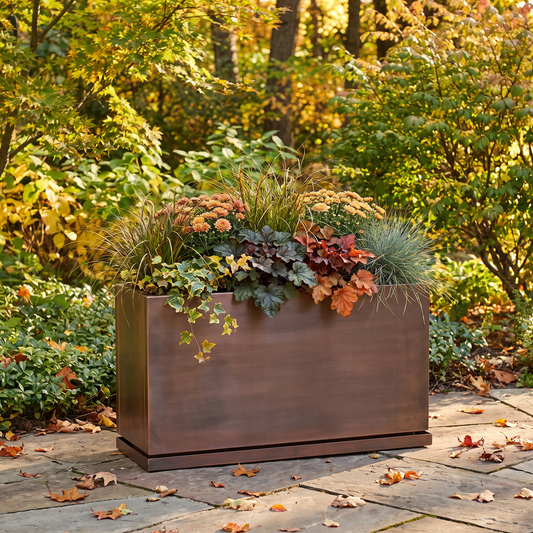 H Potter Ashbury 32-inch rectangular antique copper planter with fall flowers in an outdoor garden