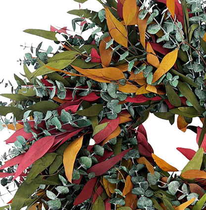 h potter brand autumn eucalyptus wreath with a mix of green, orange, yellow, and red leaves, shown against a solid white background detail view