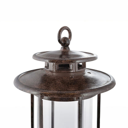 Close-up top detail of the H Potter cast iron hurricane lantern showing the vented metal lid and ring handle above the glass cylinder.