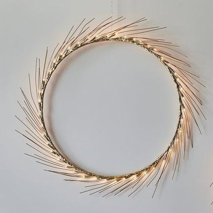 H Potter Celeste lighted wreath, large, warm LED lights on fine gold-toned spokes against a white wall