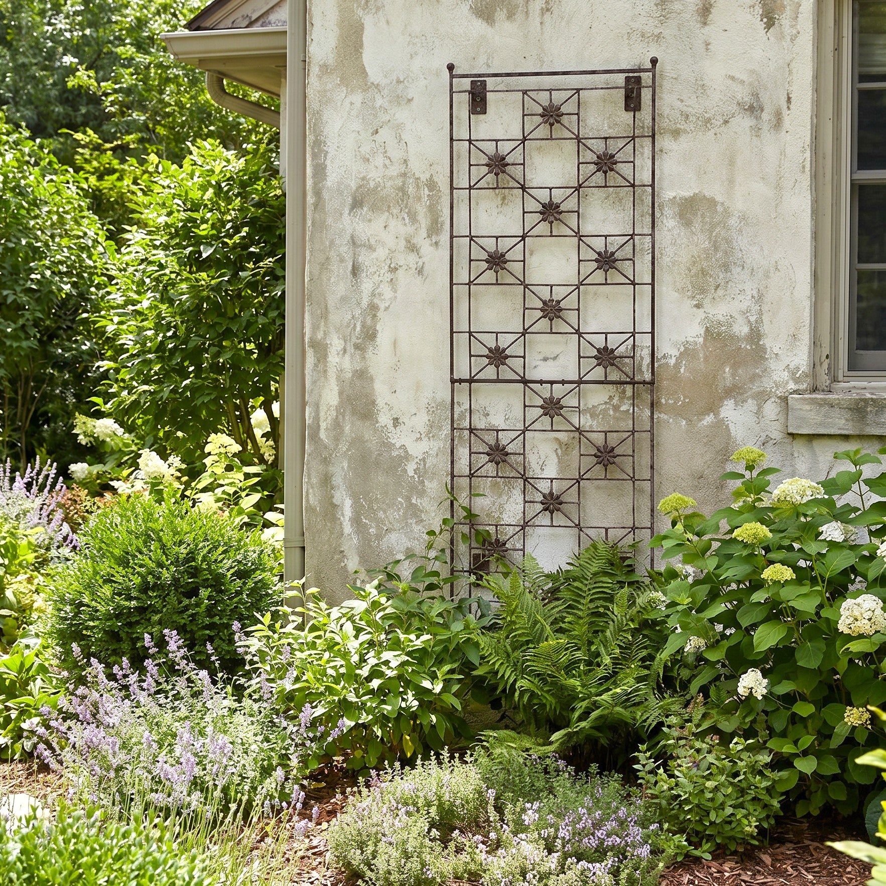 H Potter Delaney Wall Trellis on stucco house with green plants