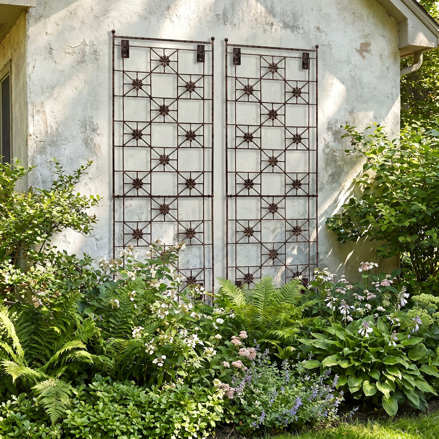 H Potter Delaney wall trellis on a house in a garden with green plants and hostas