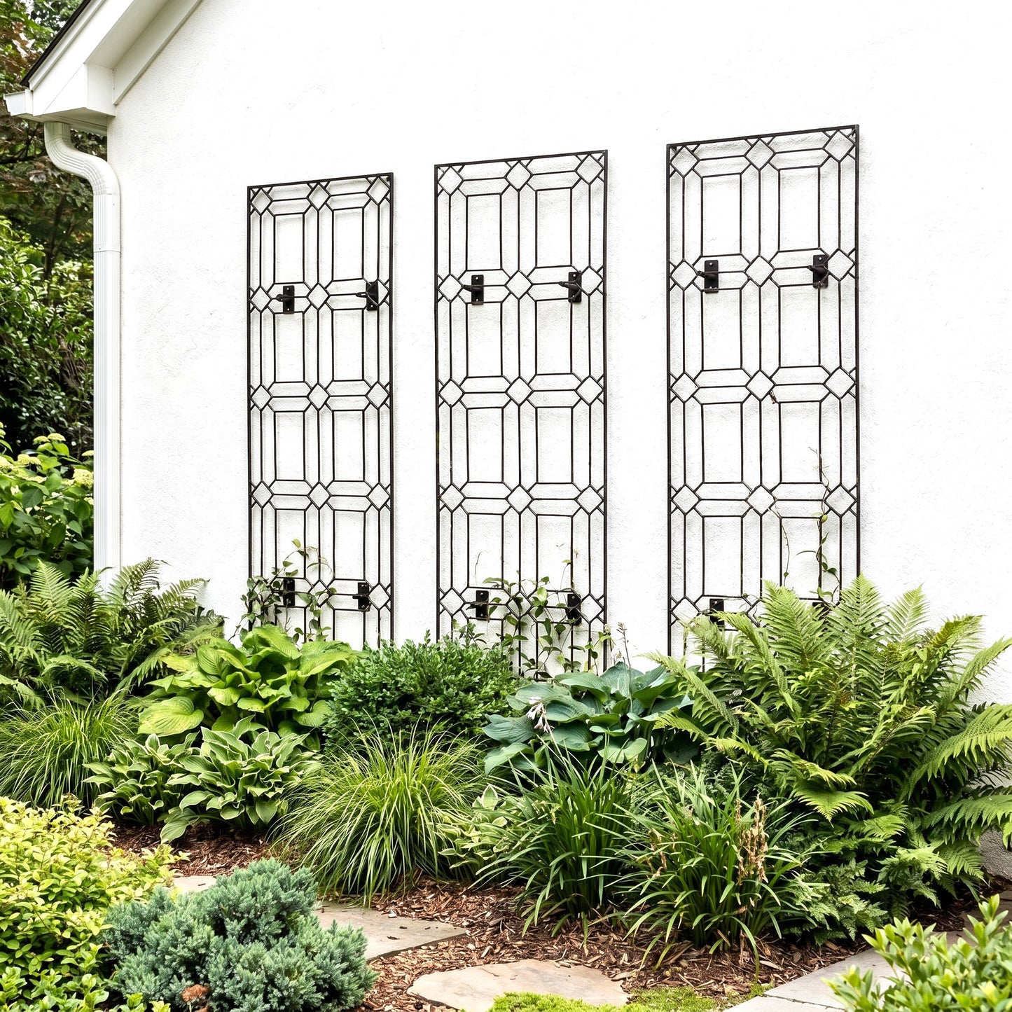 h potter set of 3 metal wall trellises on a house with green plants