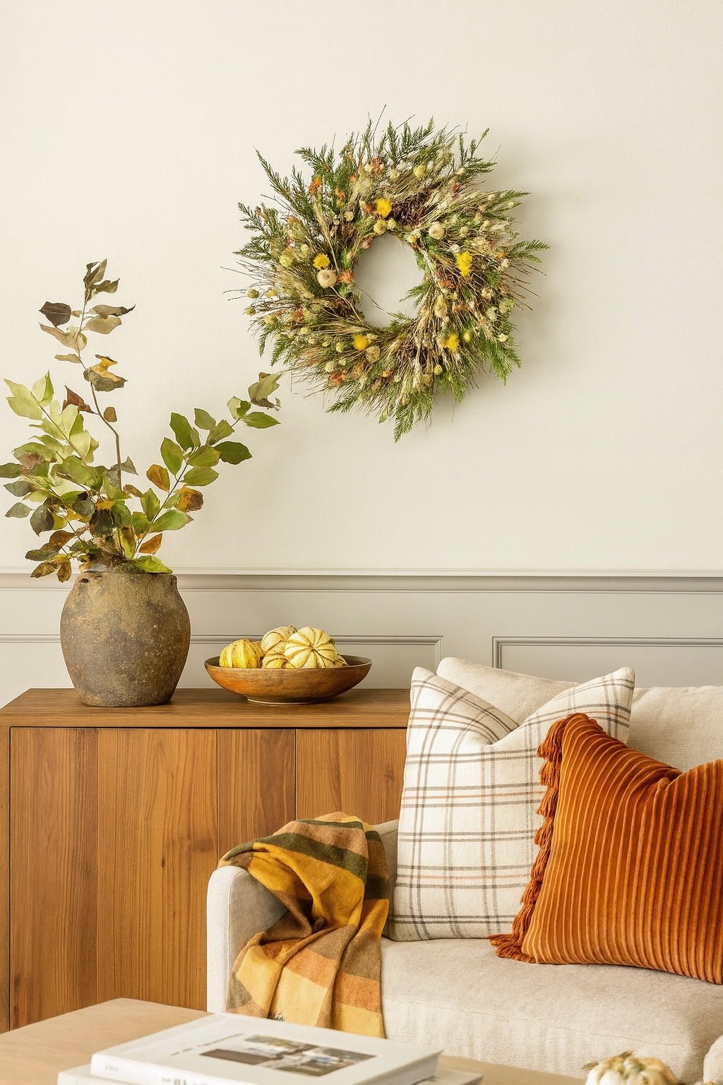 H Potter autumn bramble wreath in living room—handmade dried botanicals: twigs, cedar, wheat, safflower, poppy pods.
