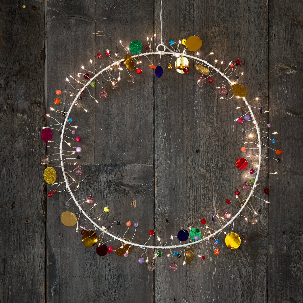 h Potter enchanted Jewel lighted wreath circle, warm fairy lights and colored glass beads on weathered grey barn wood