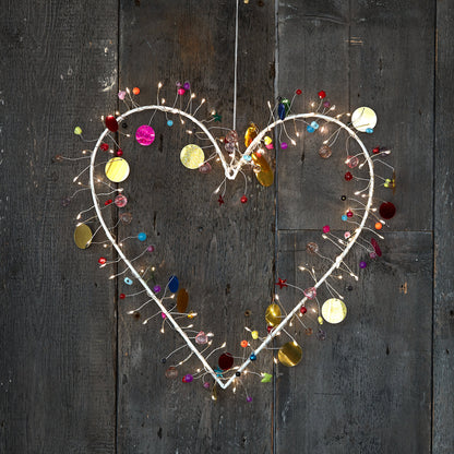 H Potter enchanted Jewel lighted heart wreath, lit with warm fairy lights and hung on rustic grey barn wood