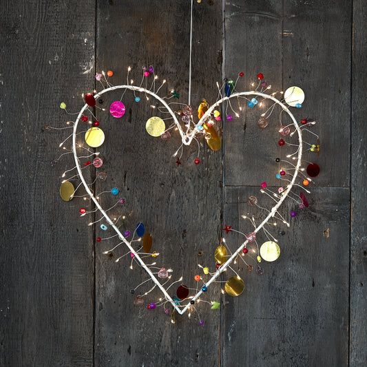 H Potter enchanted Jewel lighted heart wreath, lit with warm fairy lights and hung on rustic grey barn wood