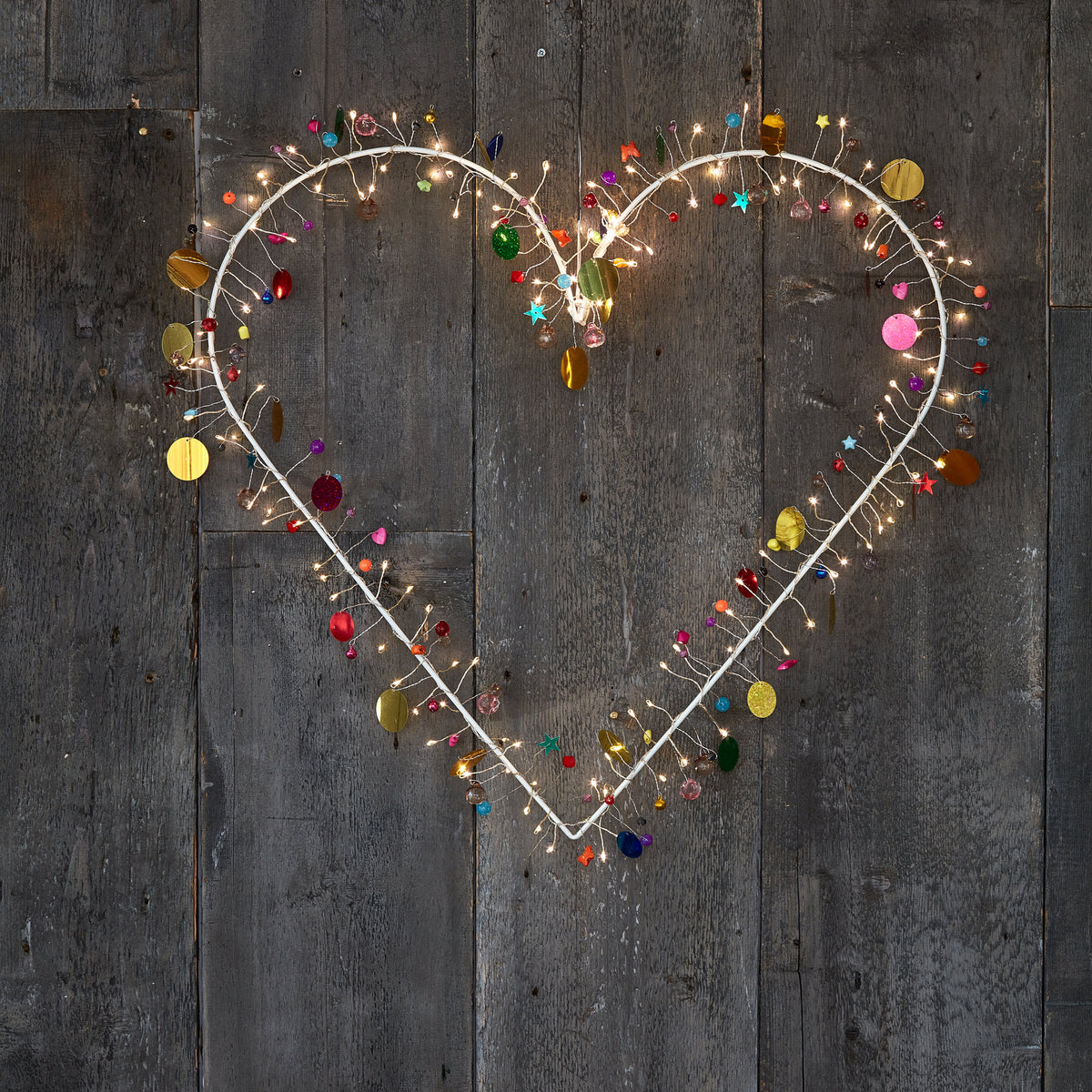 Enchanted Jewel lighted heart wreath, outlined in warm lights with multicoloured beads and gold discs