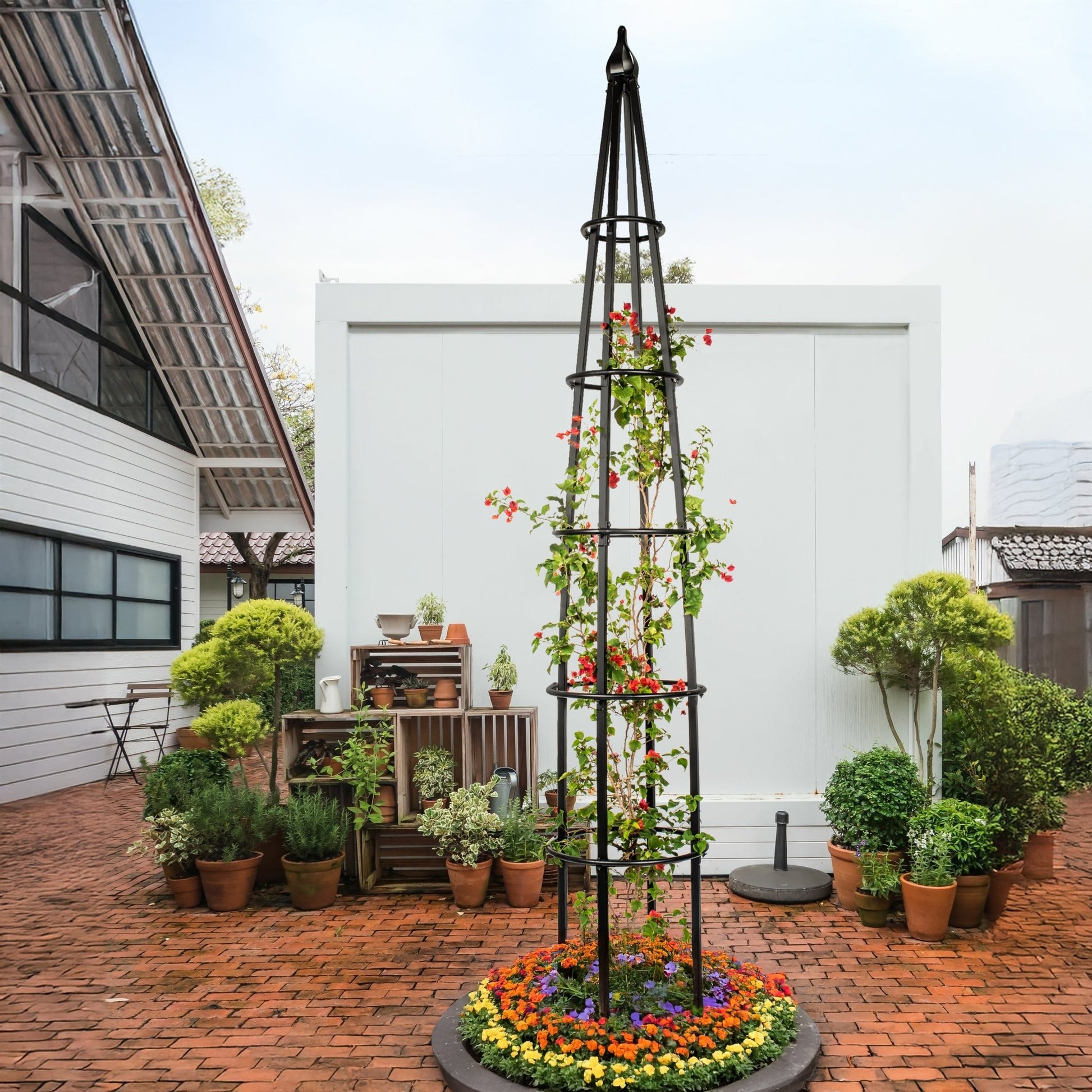H Potter estate 10 foot black metal garden obelisk trellis installed in large backyard landscape setting