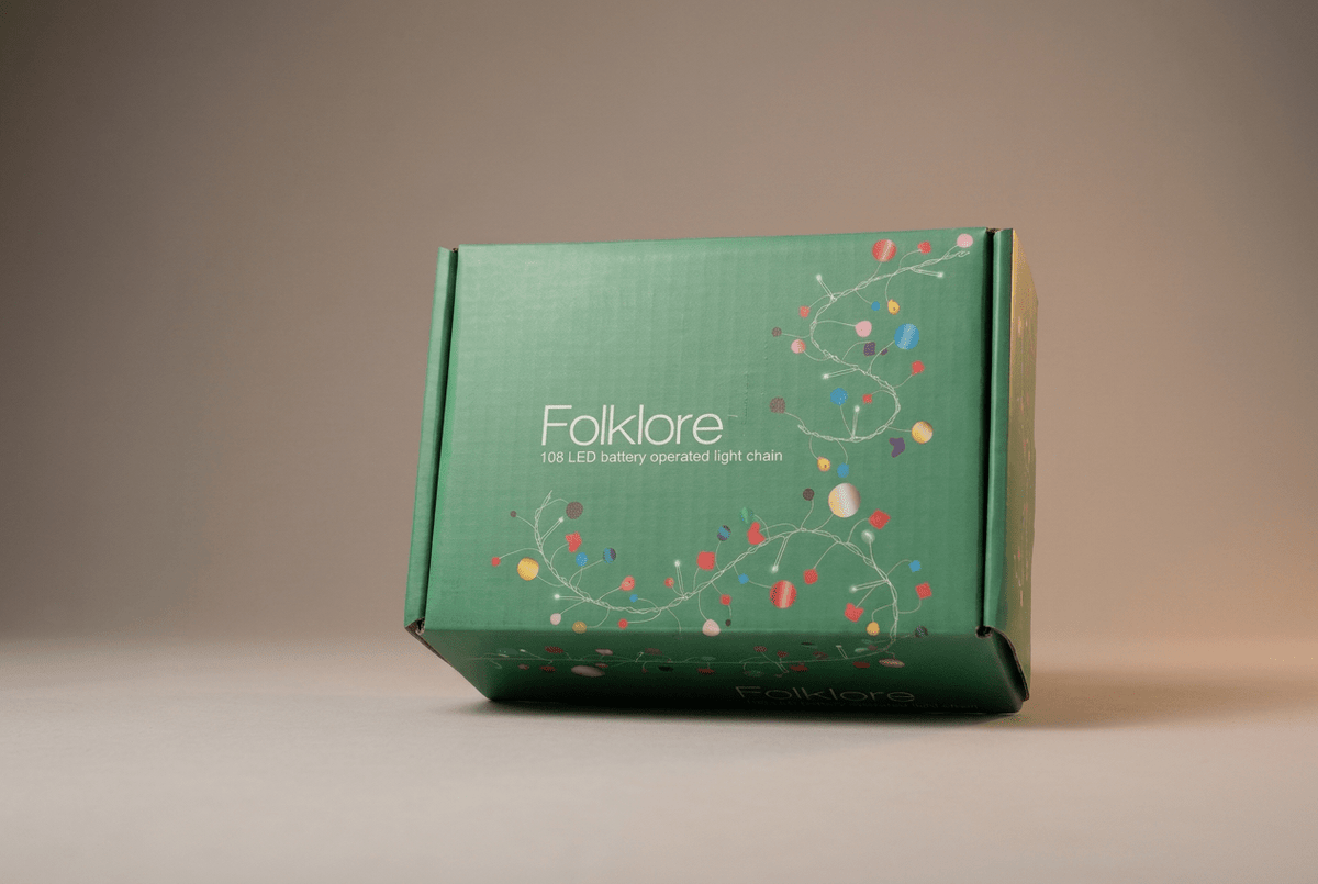 h potter green rectangular product box for the Folklore 108 LED battery operated light chain, decorated with colorful Christmas lights and white text, set against a neutral gray background.