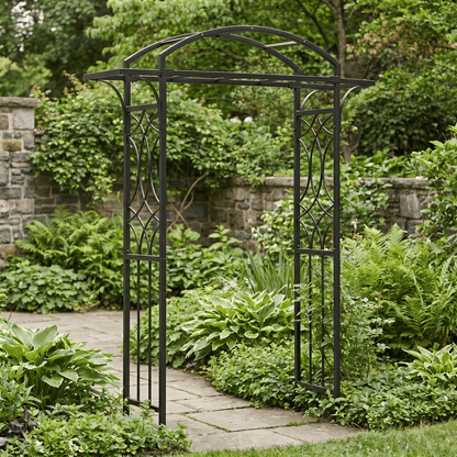 H Potter black metal garden archway in a lush garden setting with stone pathway and stone wall.