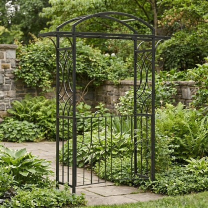 H Potter black metal garden archway in a lush garden setting with stone pathway and stone wall.