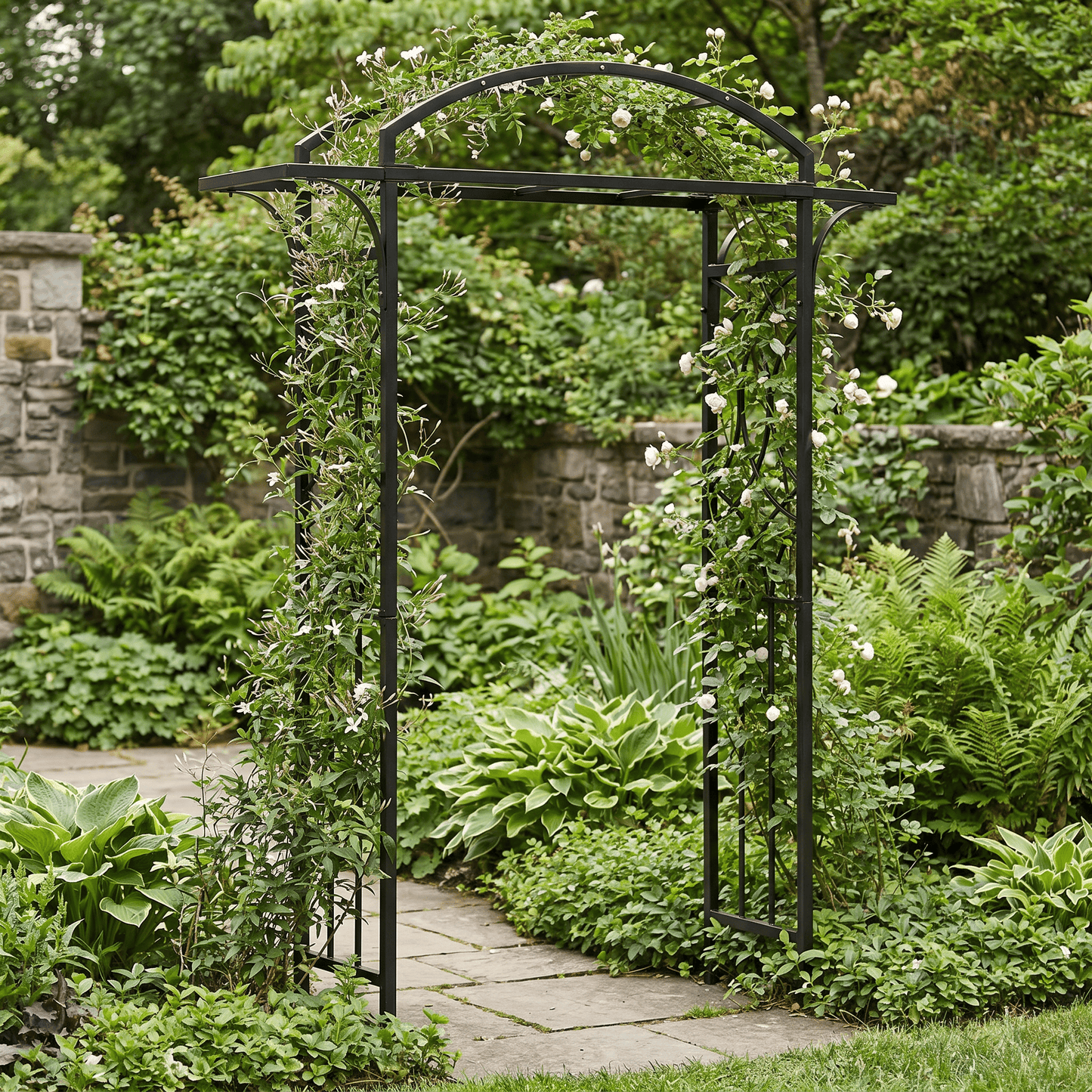 H Potter black metal garden archway with climbing plants in a lush garden setting.