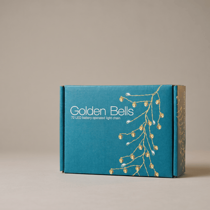 h potter teal-blue product box for Golden Bells 72 LED battery operated light chain, featuring a gold branch illustration and white text, set against a neutral beige background.