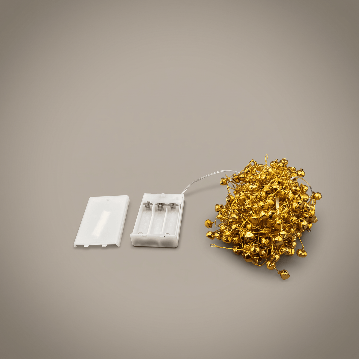 h potter Golden bells fairy lights with a white battery compartment and white cover, shown on a neutral gray background.