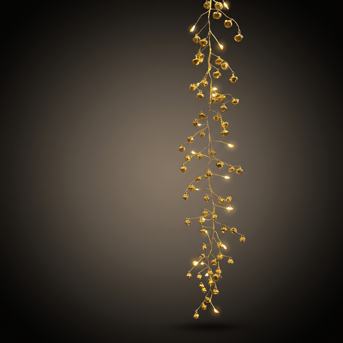 h potter string lights warm white LED fairy lights shaped like bells glowing against a dark gray gradient background.