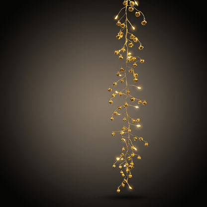 h potter string lights warm white LED fairy lights shaped like bells glowing against a dark gray gradient background.